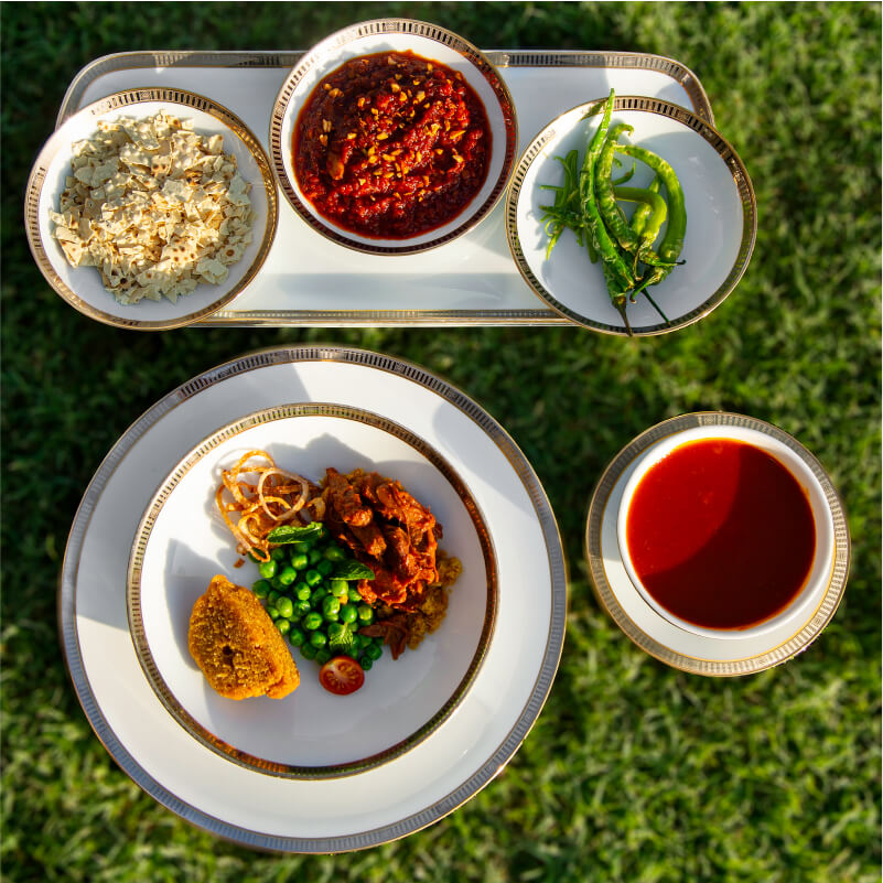 Meat-Millet Baati with Jaipur Goat Curry, Green Peas    